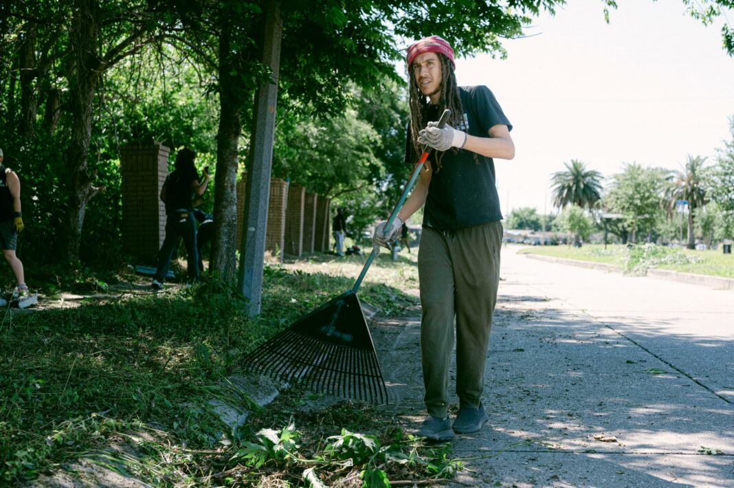 Christopher Lang rakes plants